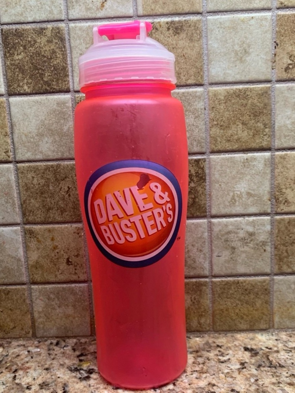Pink Plastic Dave & Buster's Branded Water Bottle with Flip-Top Lid.